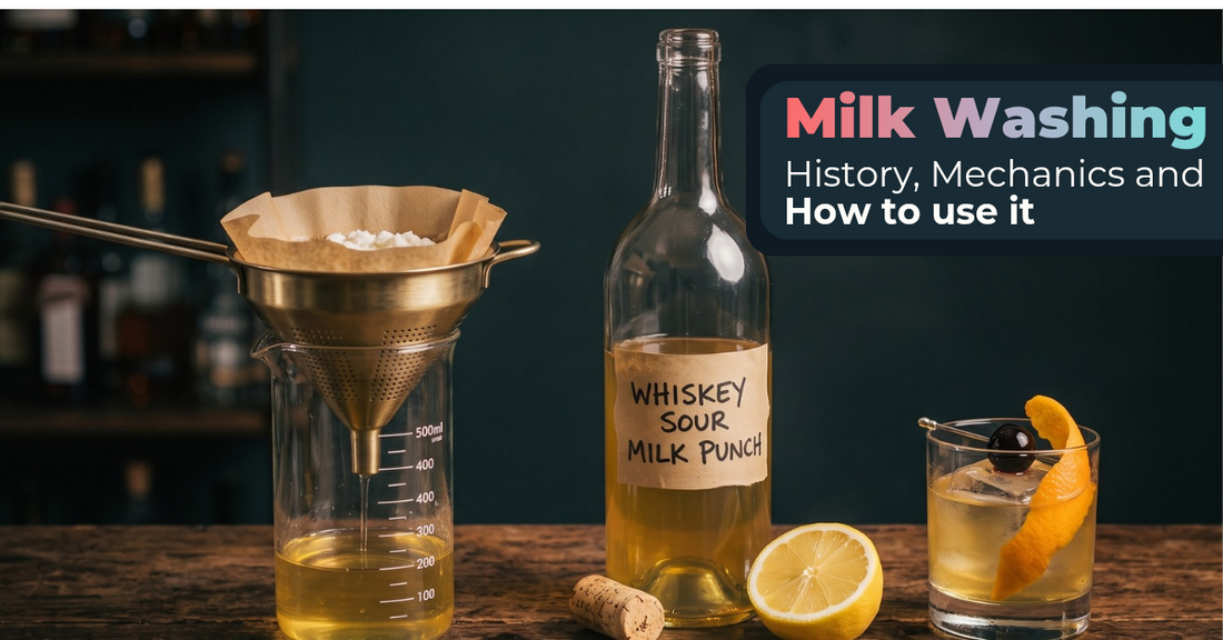 Clarified milk punch dripping through a paper filter with milk curds into a glass beaker on a dark wooden bar counter next to fresh lemon and a whiskey sour milk punch cocktail bottle.